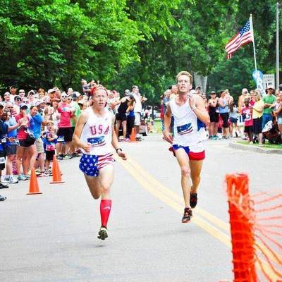 Runners sprinting at the end of the FireKracker 5k elite race.